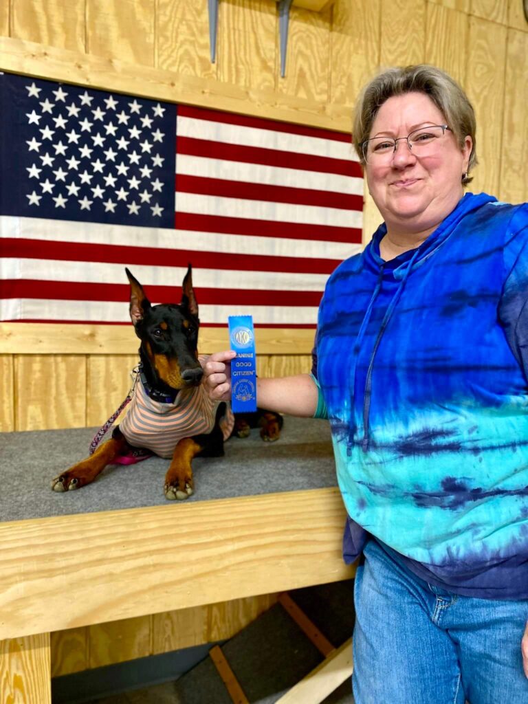 dog laying on platform by it's owner