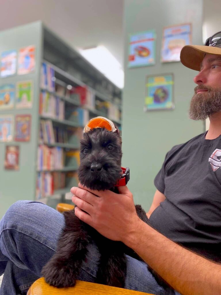 man holding puppy in lap
