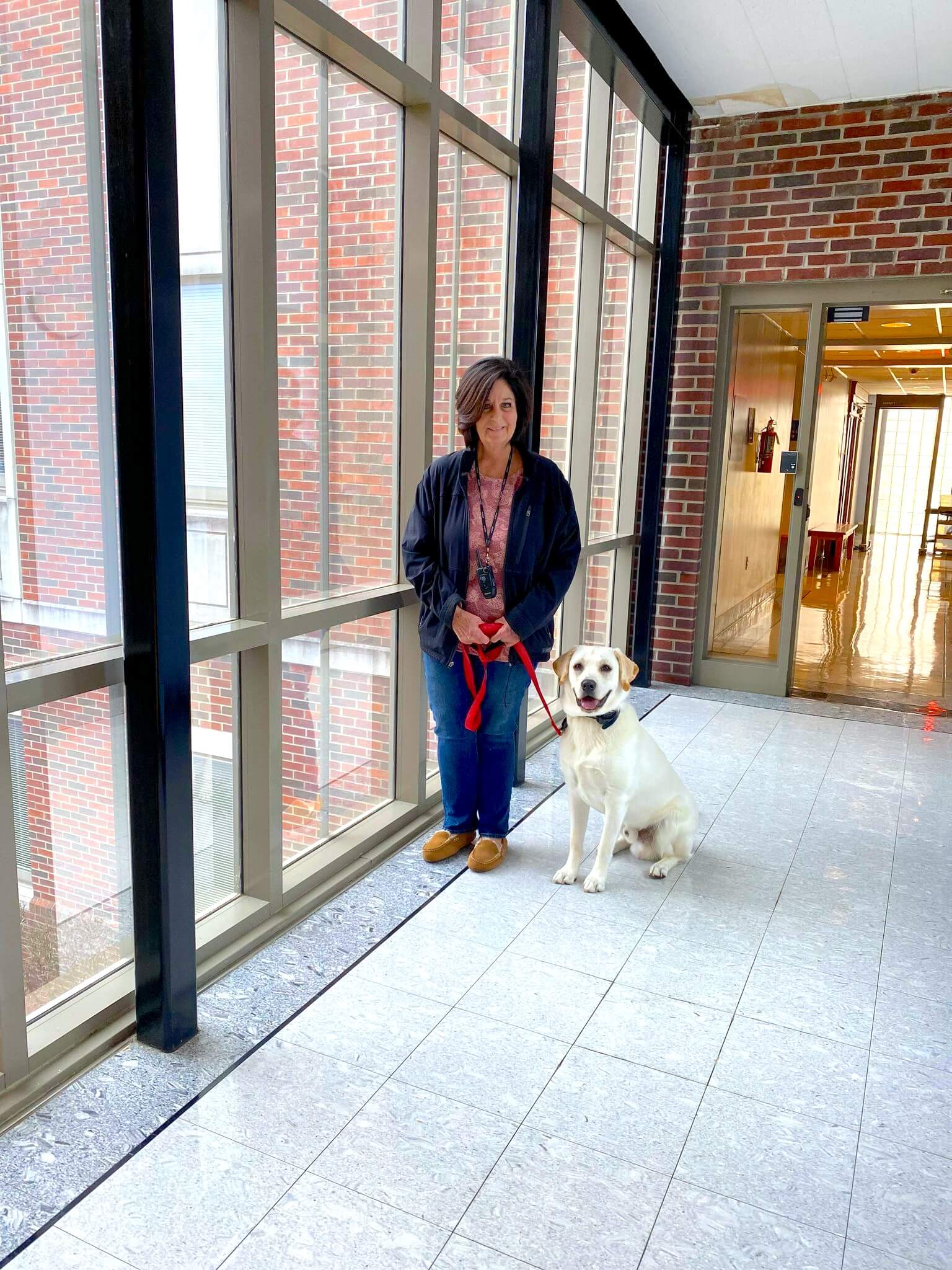 woman standing with dog beside her